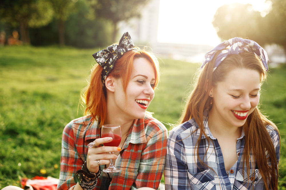 Girls having a drink at a picnic